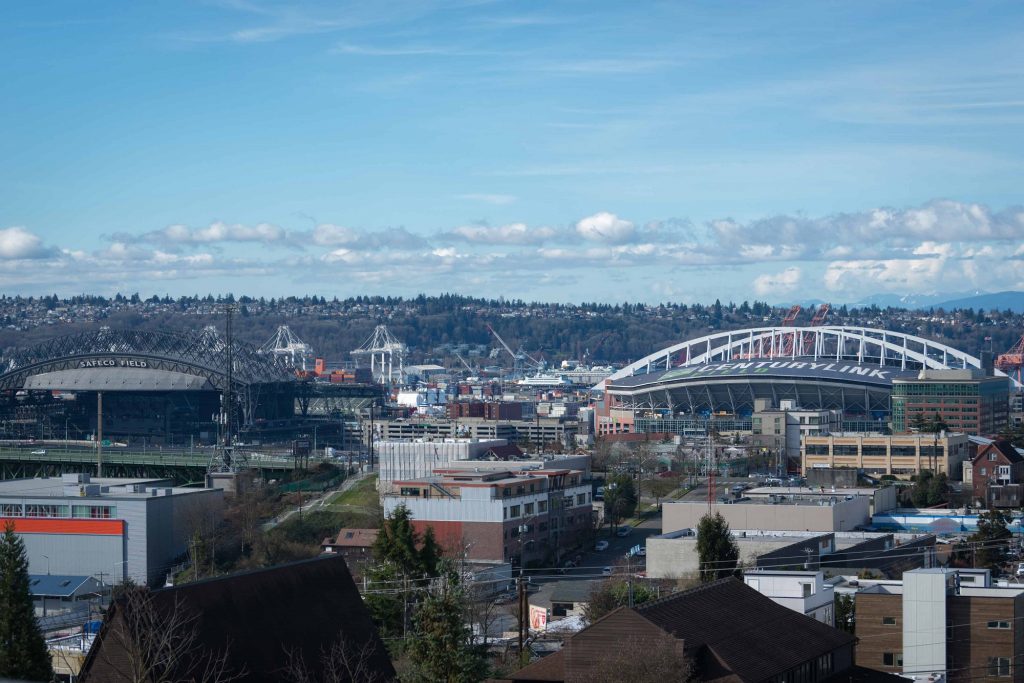 View of nearby lake, stadium, and surrounding city from top of apartment complex