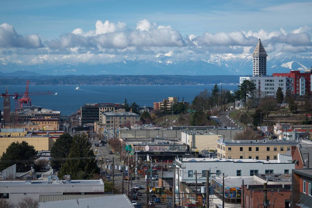 View of nearby lake, forest, and surrounding city from top of apartment complex