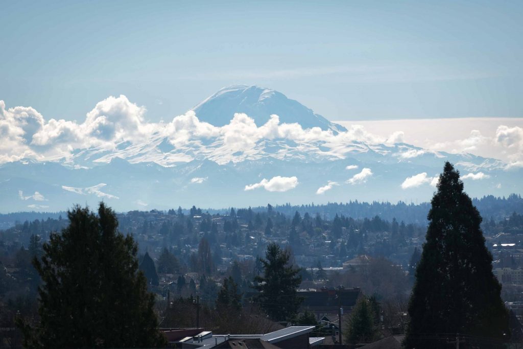 View of nearby mountains and forest from top of apartment complex