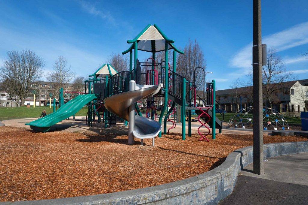 Nearby playground area with slides and climbing obstacles for kids