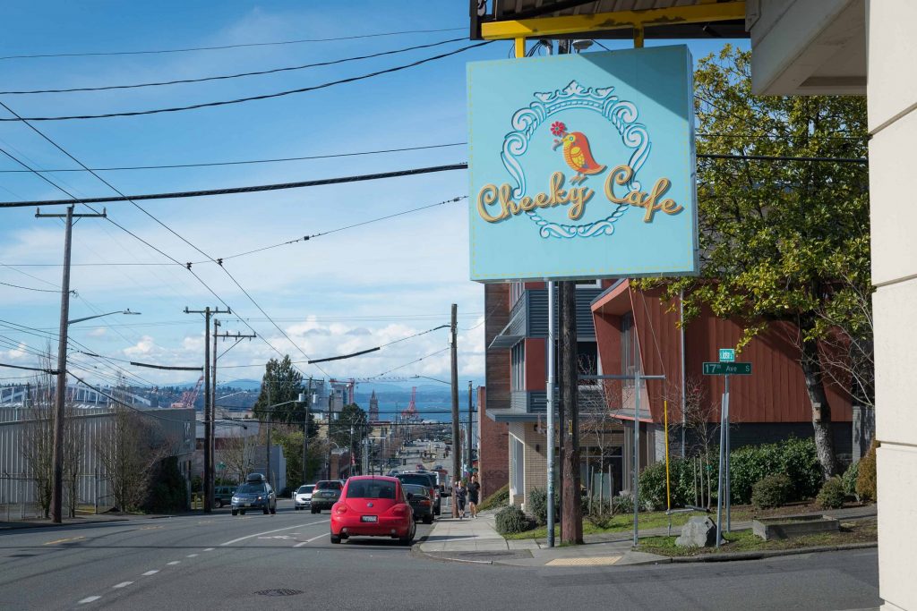 Street view of sign for nearby Cheeky Cafe store