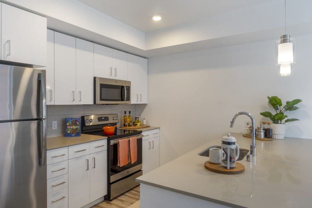 Bell Jackson Street kitchen with white cabinetry and stainless steel refrigerator